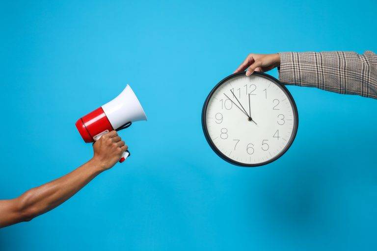 hands-showing-megaphone-and-holding-clock-2025-03-17-05-53-51-utc